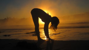 forwrad fold pose yoga sunrise